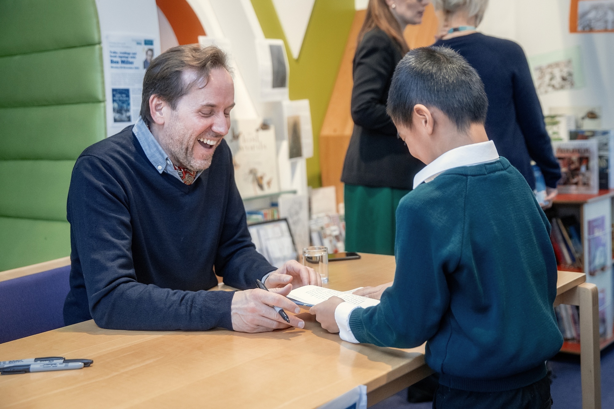 Ben Miller signs a book for a Junior School pupil