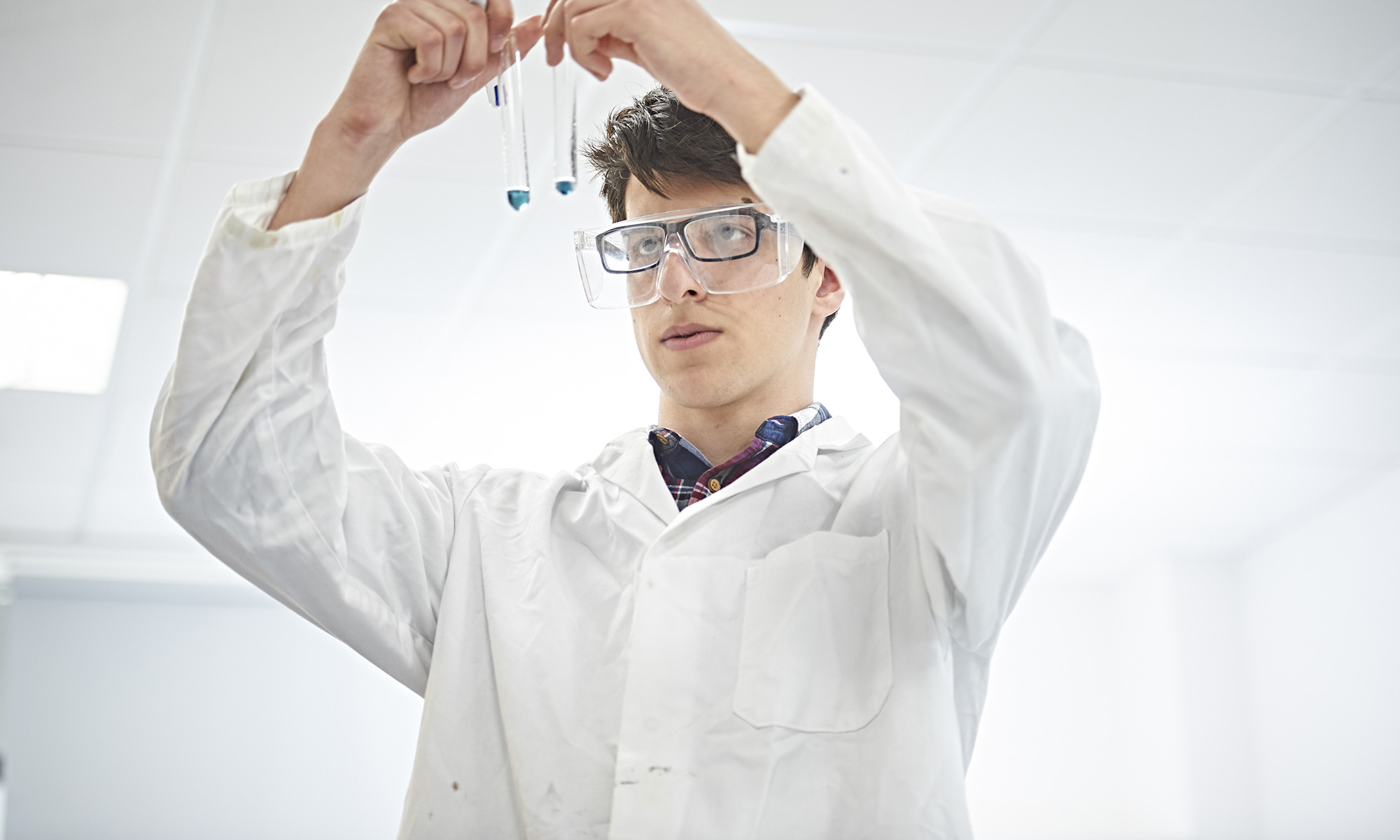 Image of student in science class to illustrate link to 'Combined Science' page