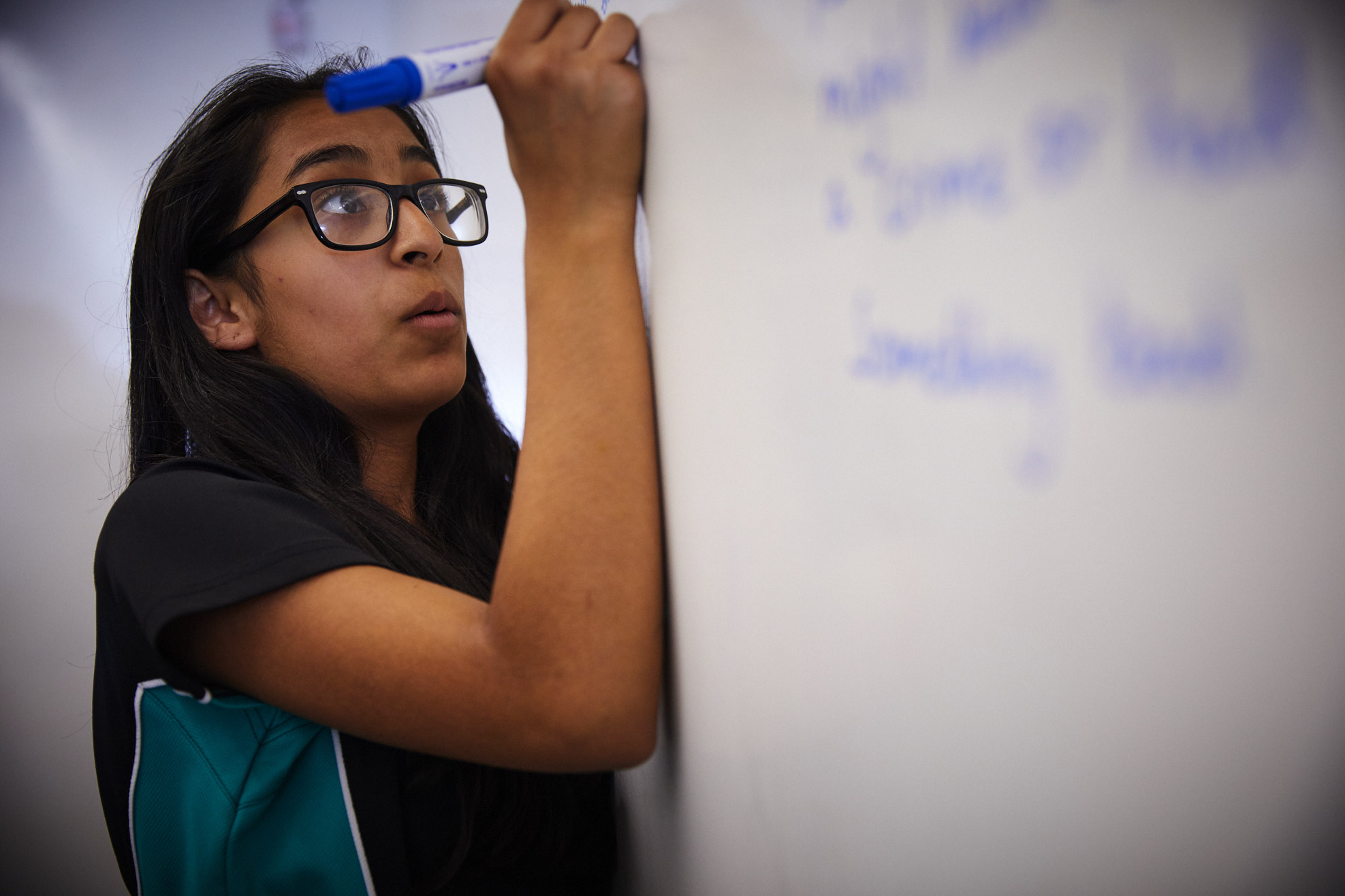 Student writing on whiteboard